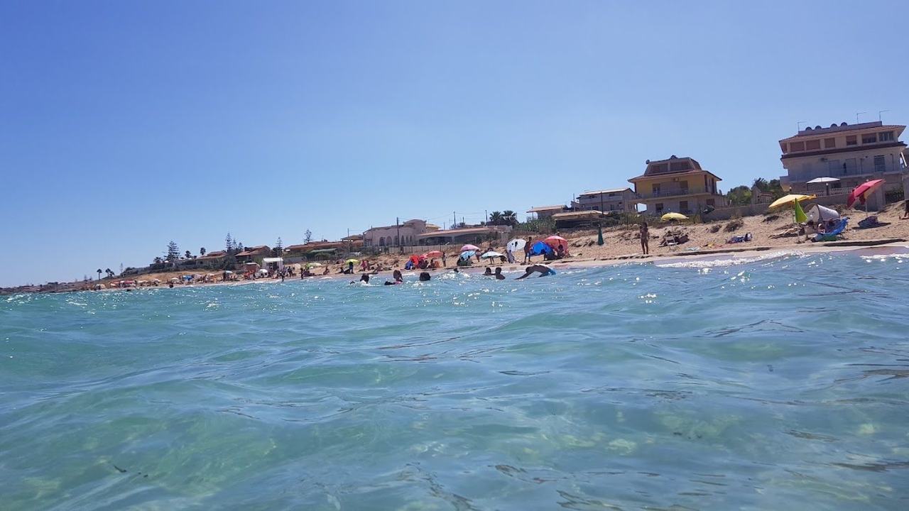Shallow turquoise bay and soft sand at San Lorenzo beach near Marzamemi Sicily