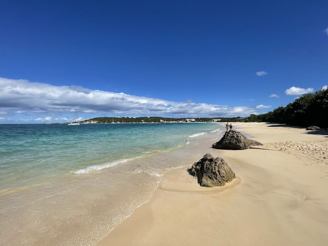 Calm water and moored boats along the harbour beach at Sandy Ground on Road Bay in Anguilla