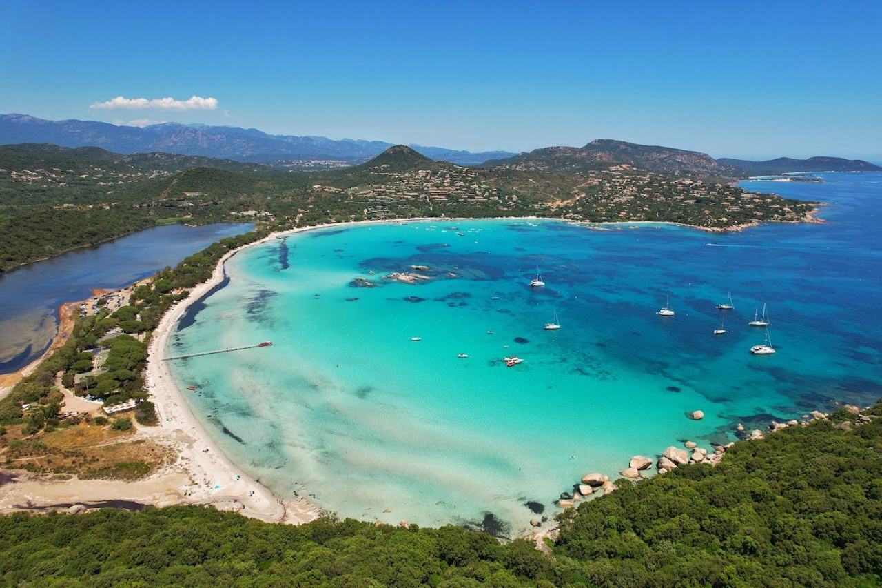 White sand and warm shallow turquoise lagoon water at Santa Giulia near Porto Vecchio in Corsica