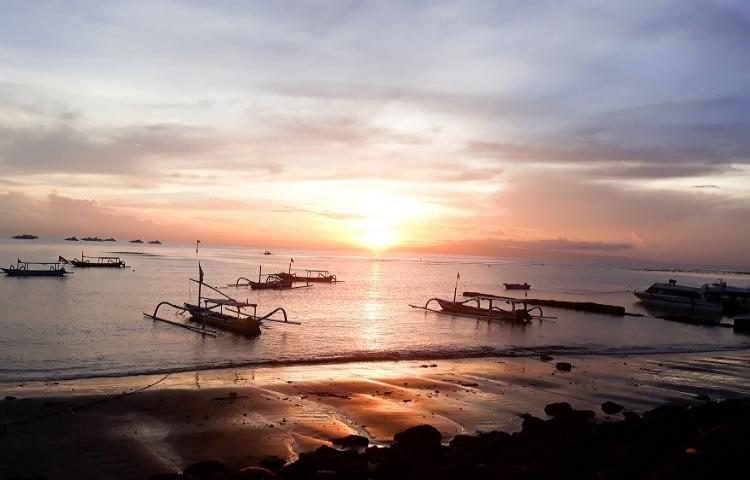 Calm reef sheltered water and light sand at Sanur Beach in east Bali at sunrise