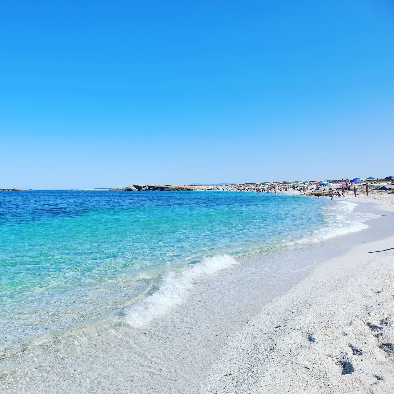 Pale quartz grains and turquoise water at Is Arutas beach on the Sinis peninsula of western Sardinia
