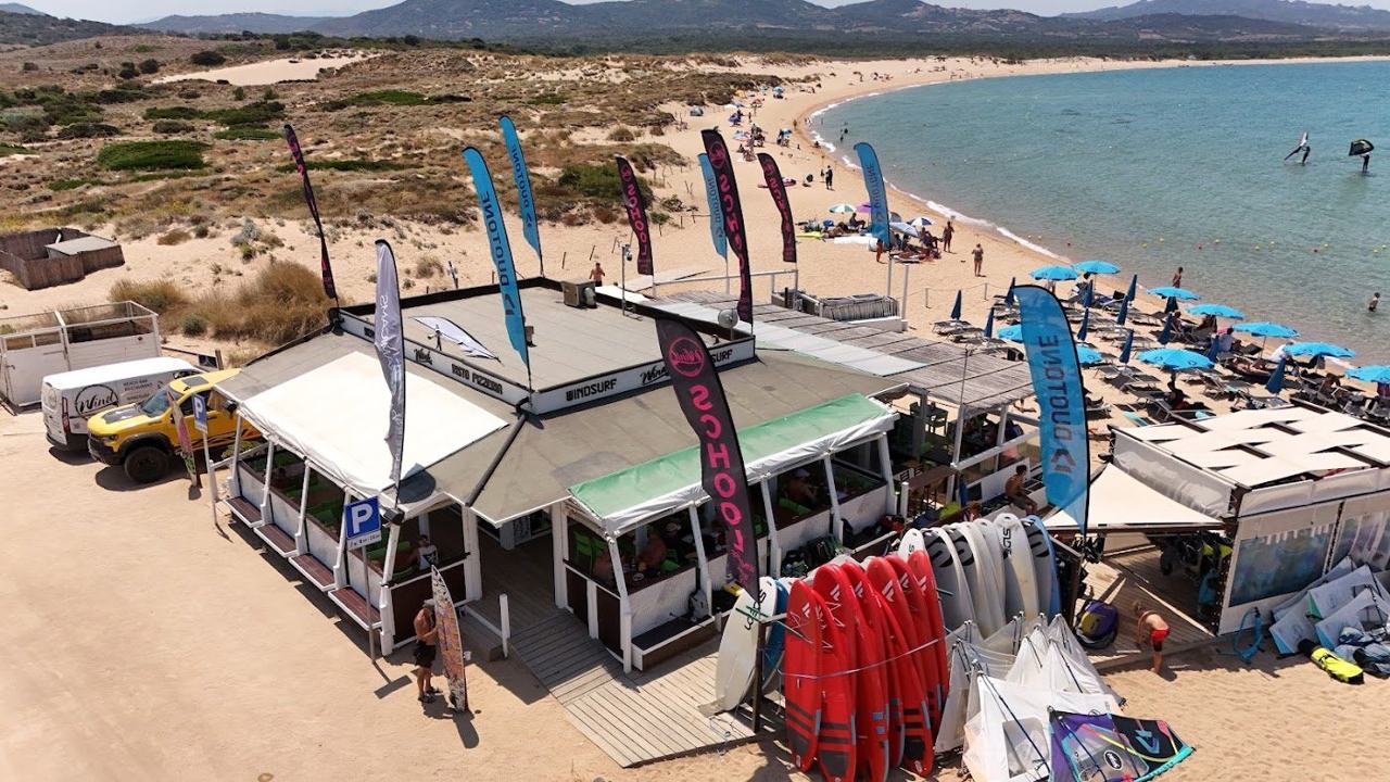 Windsurfers and kitesurfers on the breezy water near Palau in northern Sardinia