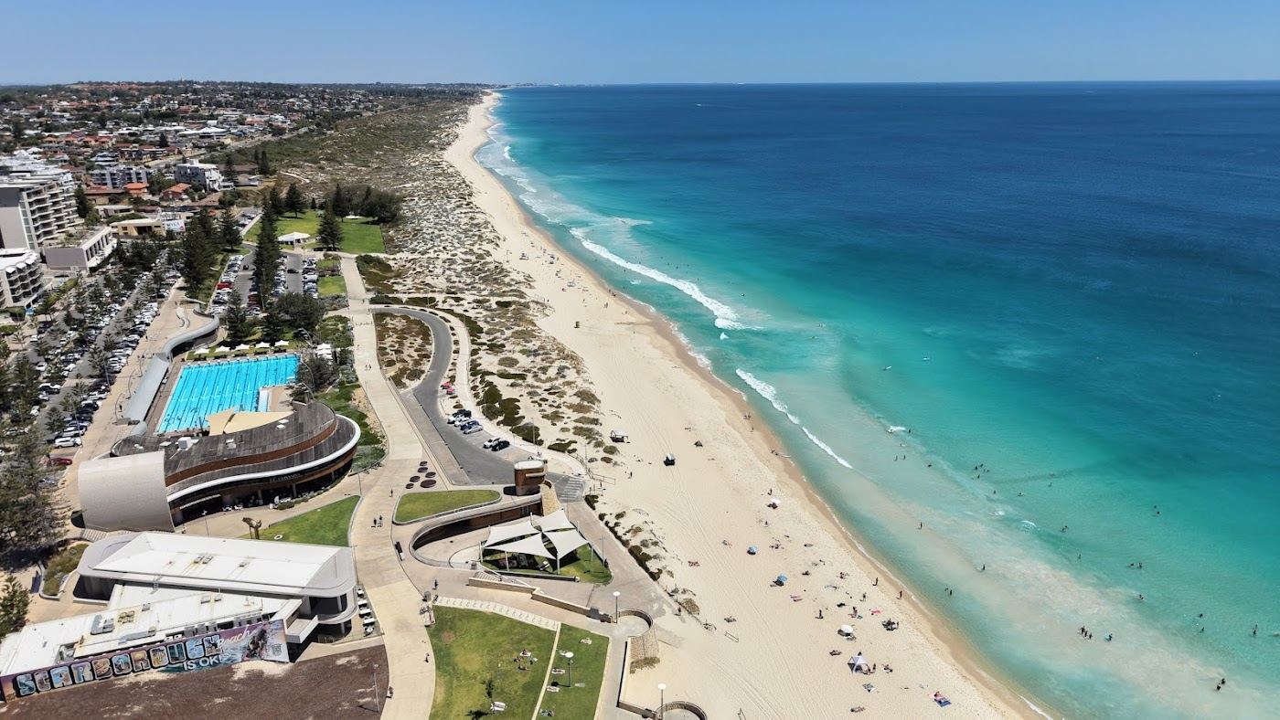 The wide white sand and surf of Scarborough Beach below its redeveloped foreshore in Perth, Western Australia