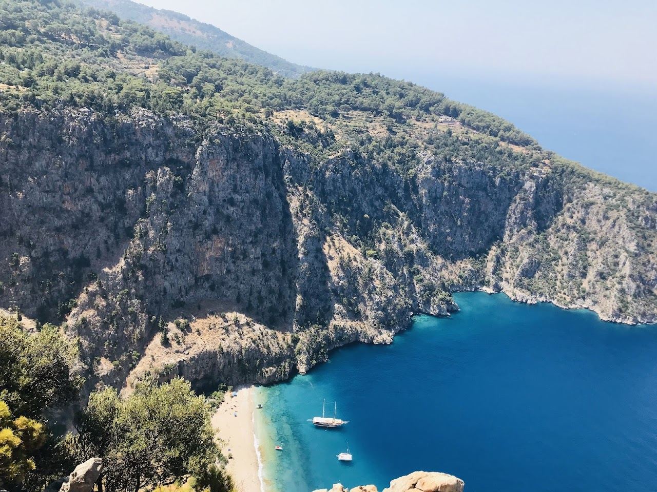 The steep canyon walls framing the clear cove at Butterfly Valley near Oludeniz