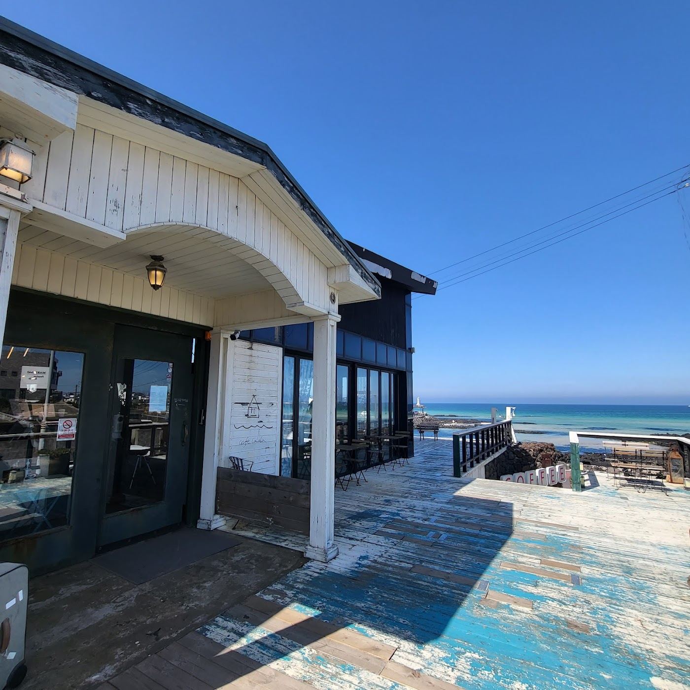 Emerald water over white sand and black basalt at the small cove of Sehwa Beach on the northeast coast of Jeju