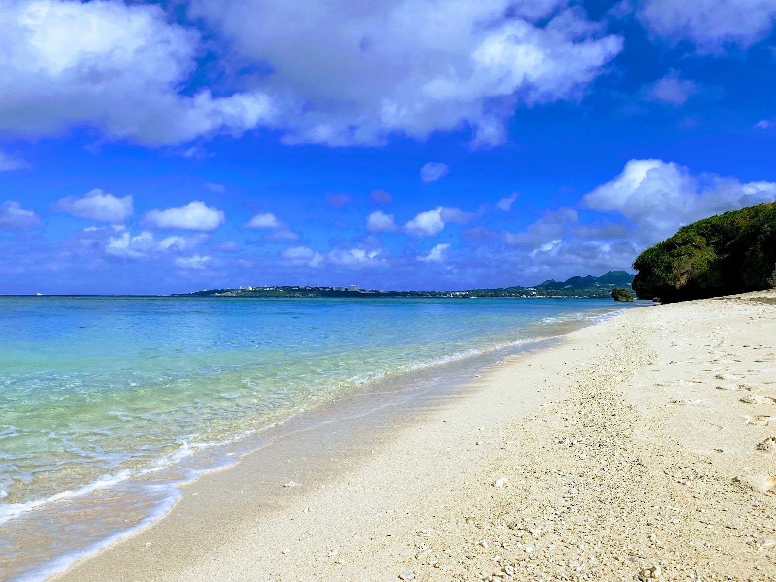 Clear shallow reef water and pale coral sand at Sesoko Beach on Sesoko Island in Okinawa