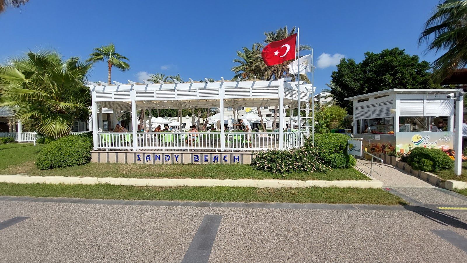 The wide sandy shore and gentle sea at Side near Antalya with the ancient town behind