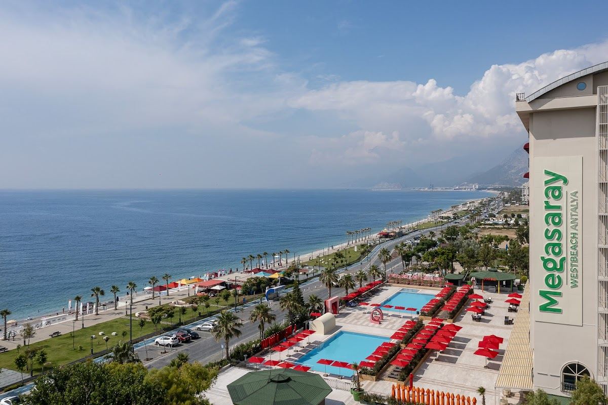 Sunbeds and gentle shallow water on the soft sand of West Beach at Side near Antalya