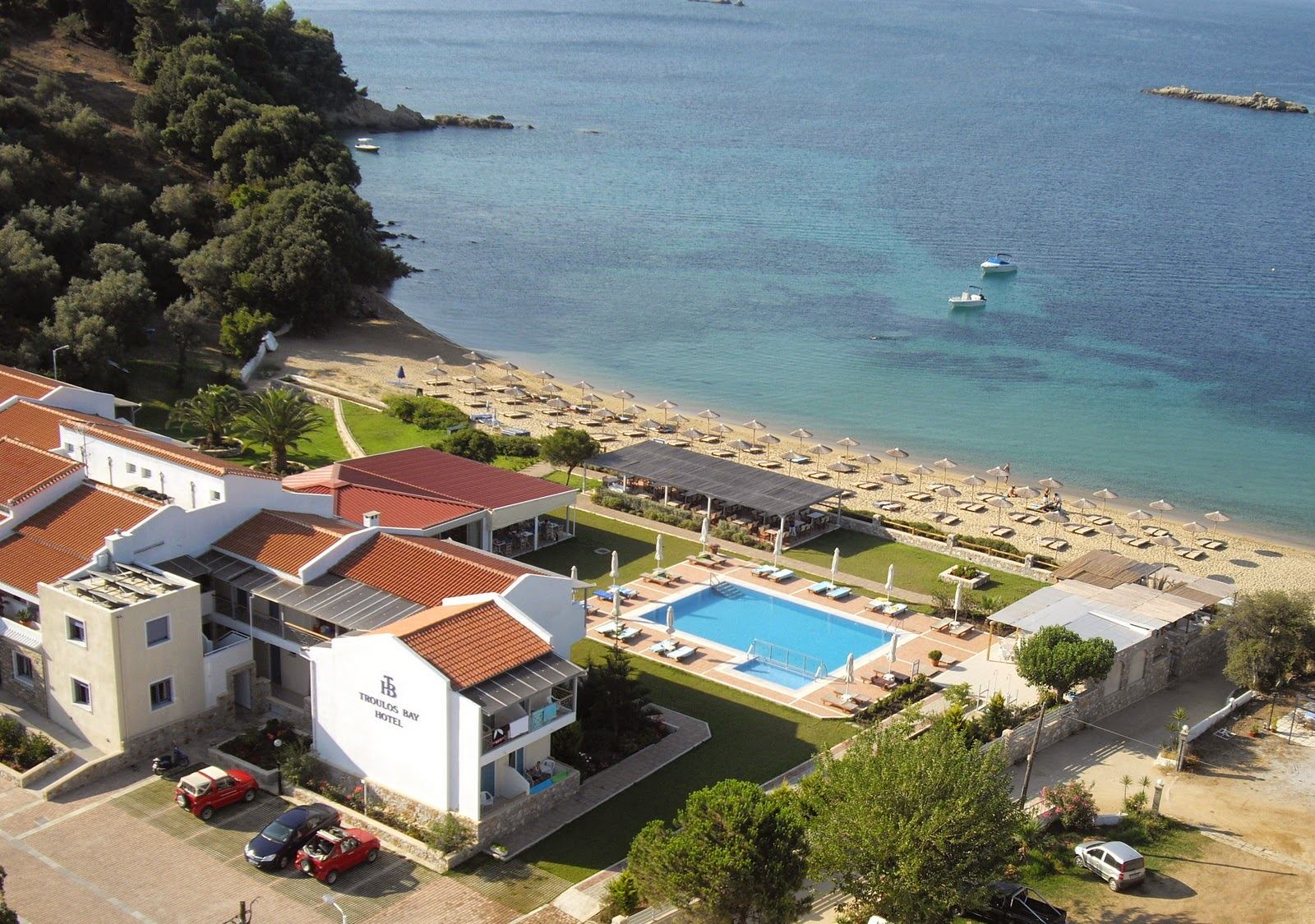 A gentle shallow family beach with calm water and pine shade on Skiathos