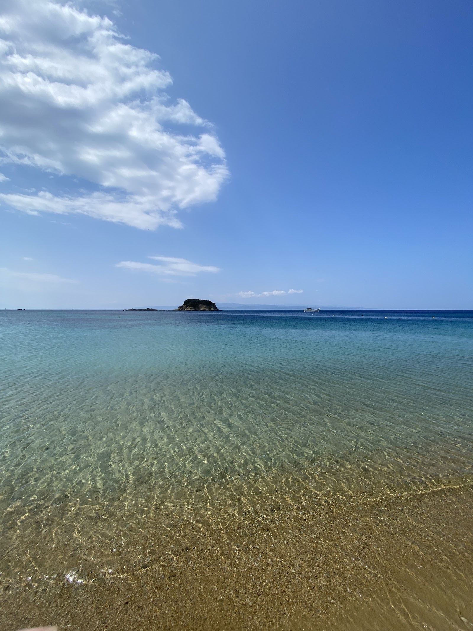 Soft golden sand and calm clear shallows at Troulos family beach on Skiathos