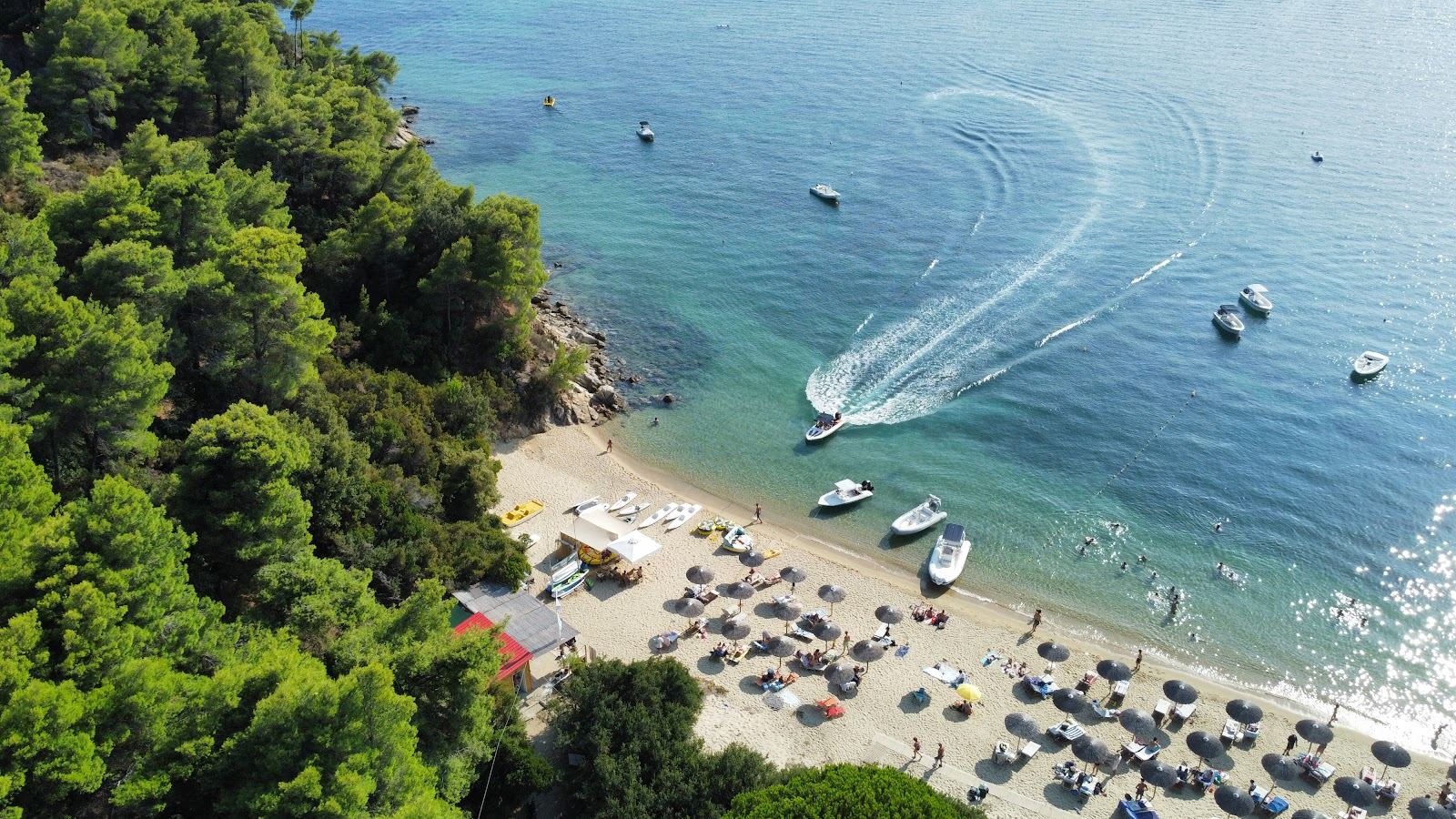 Watersports and calm shallow water at Vromolimnos beach on Skiathos