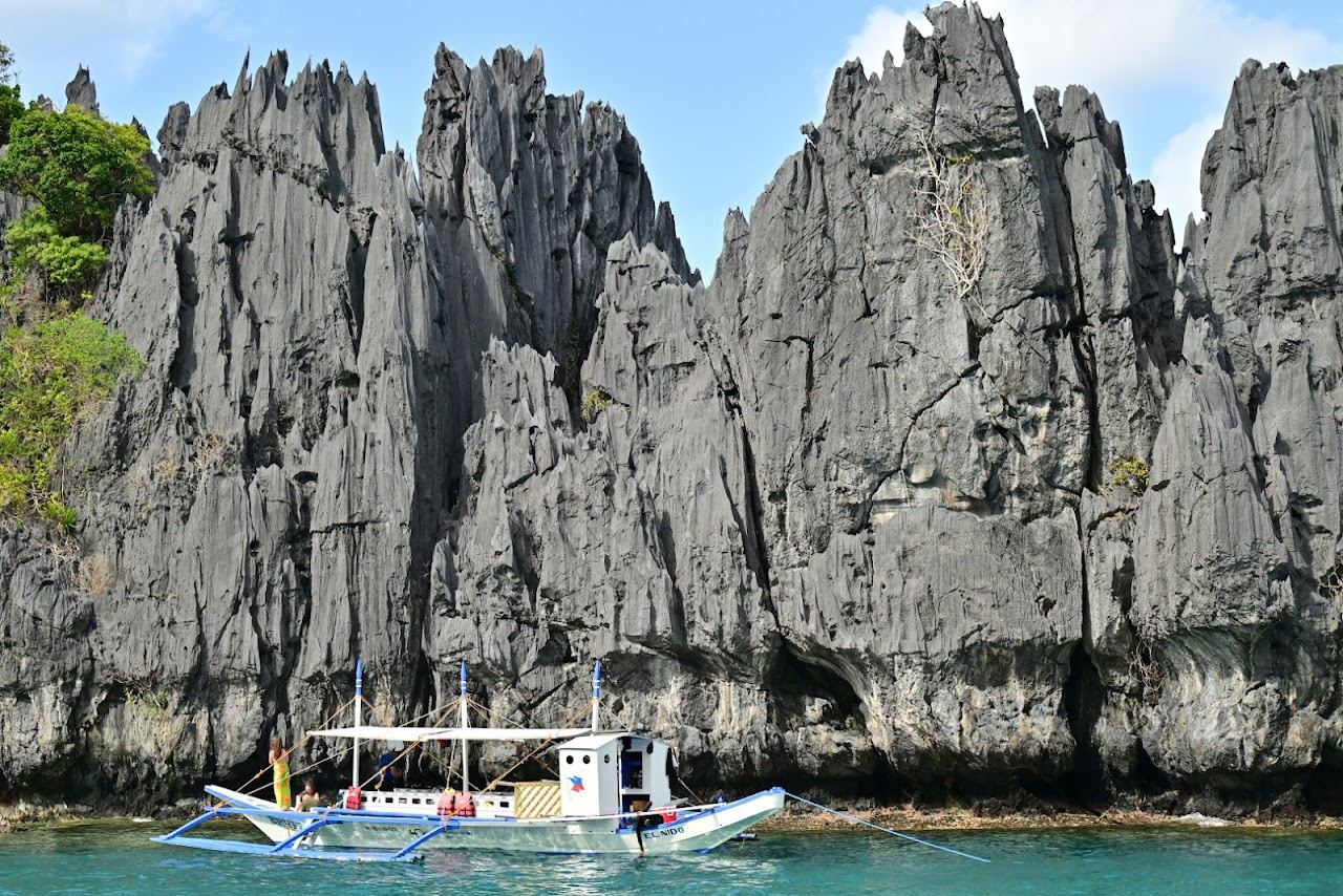 Small Lagoon hidden emerald pool and limestone walls on Miniloc Island near El Nido