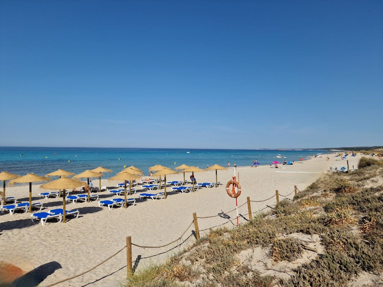 The long open sand of Son Bou beach in Menorca