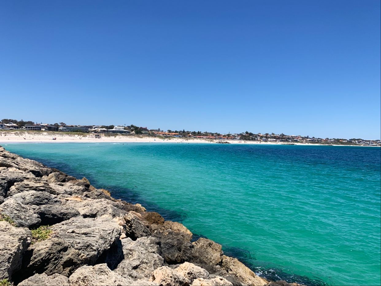 The soft golden sand and calm morning water of Sorrento Beach in the northern suburbs of Perth