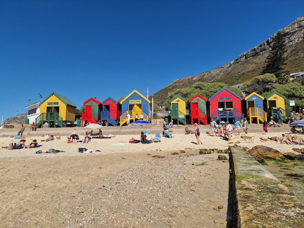 The colourful bathing boxes and tidal pool of St James on False Bay near Boulders in Cape Town