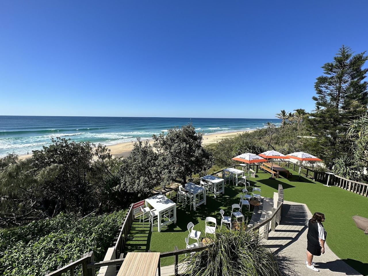 The long open surf beach and forested dunes at Sunshine Beach in Noosa, Queensland