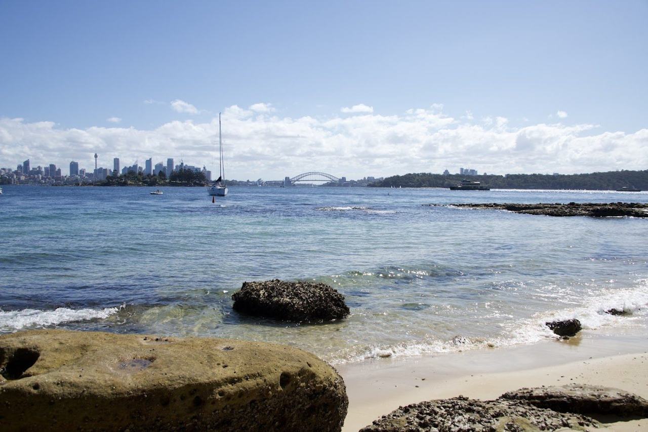 The Sydney skyline framed across the harbour from Milk Beach at Vaucluse in Sydney