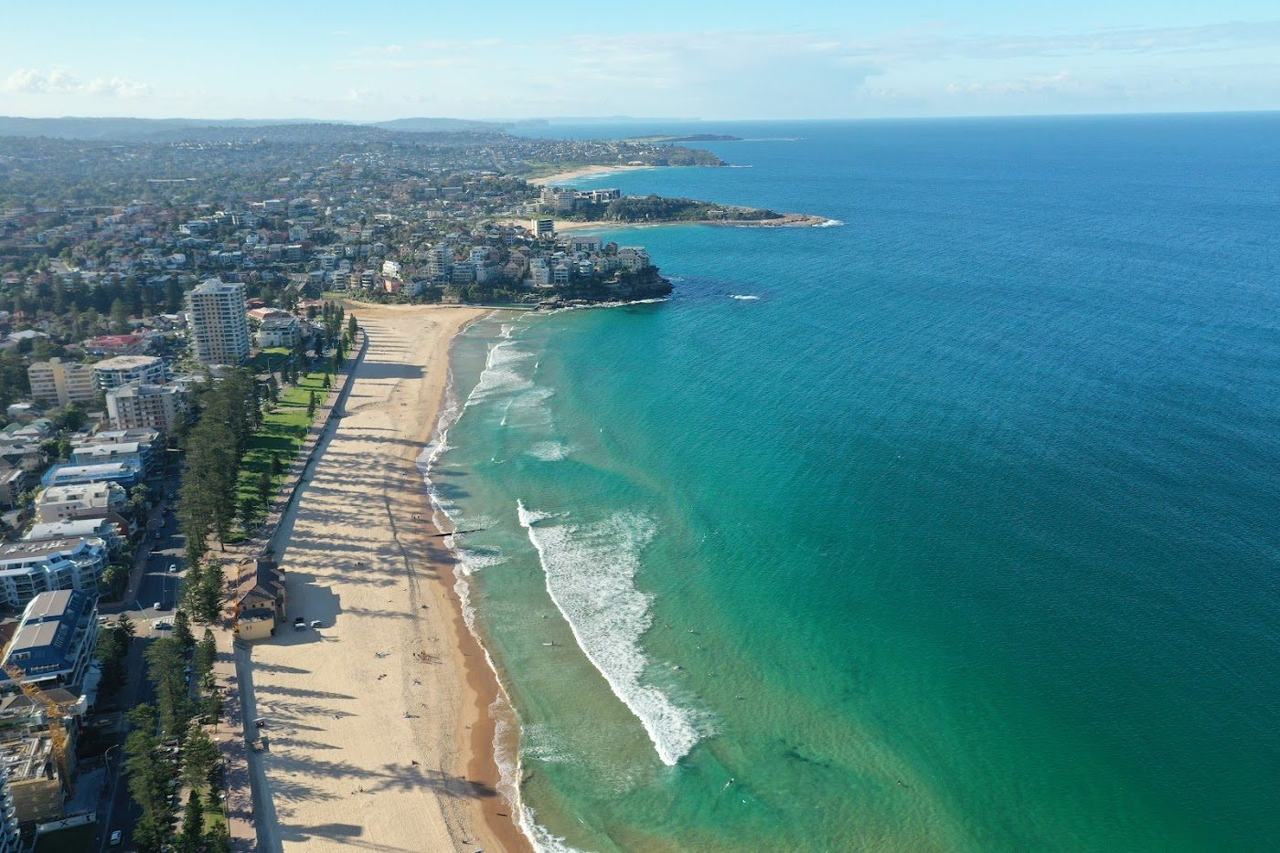 Surfers in the water off Manly Beach on the northern beaches of Sydney Australia