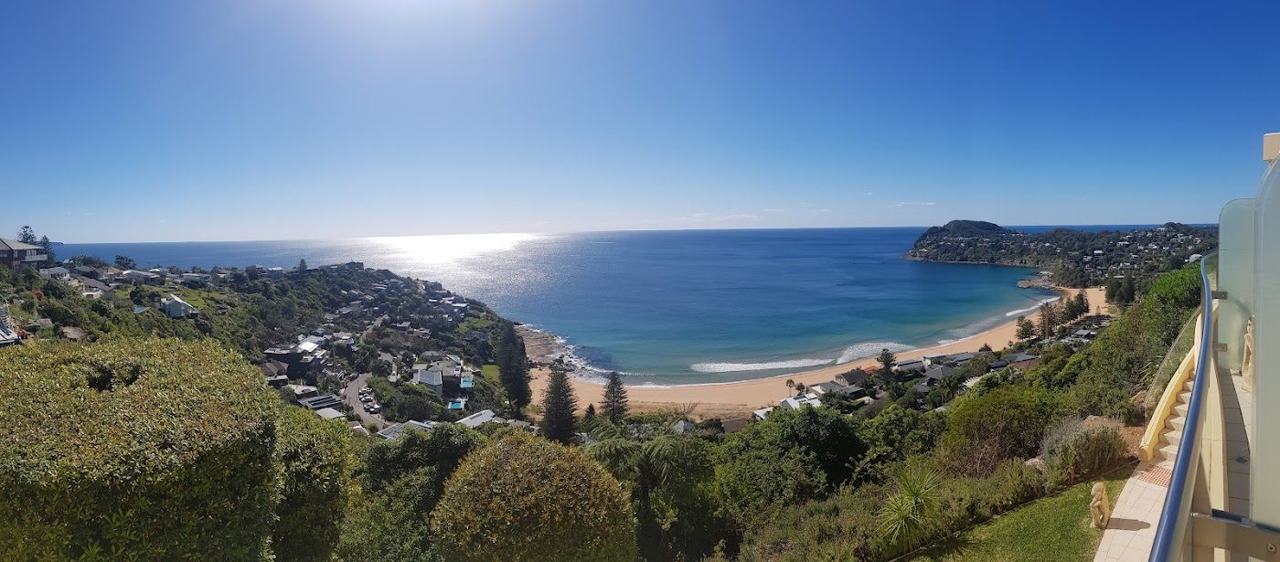 The deep gold crescent of sand and headlands at Whale Beach in Sydney
