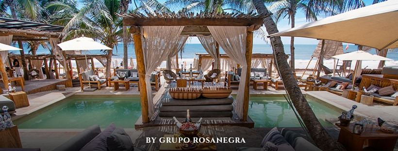 Whitewashed dune restaurant and wooden loungers at Taboo Beach Club on the Tulum hotel zone