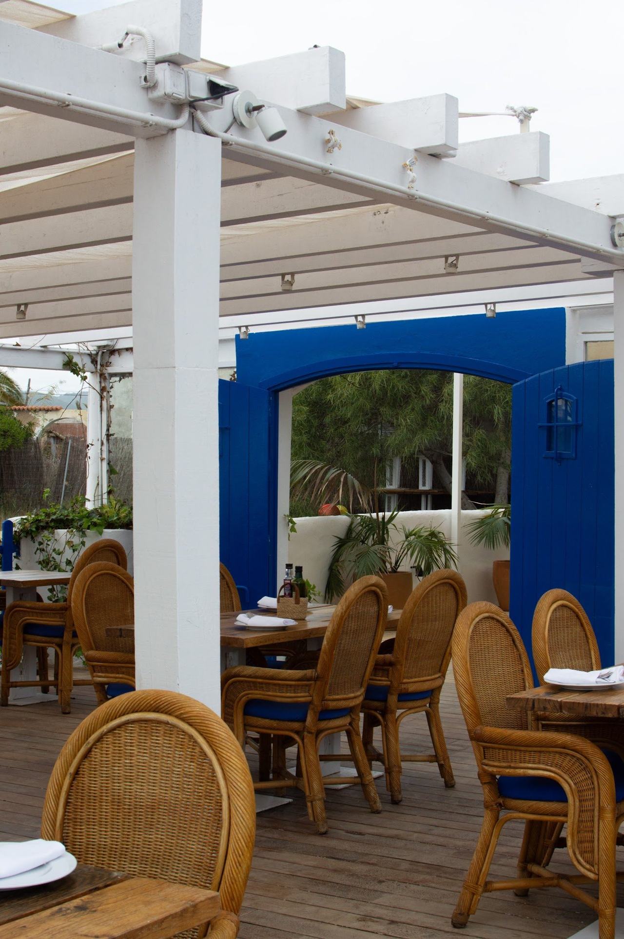 Beachfront restaurants and calm shallow water along the sheltered bay at Talamanca in Ibiza