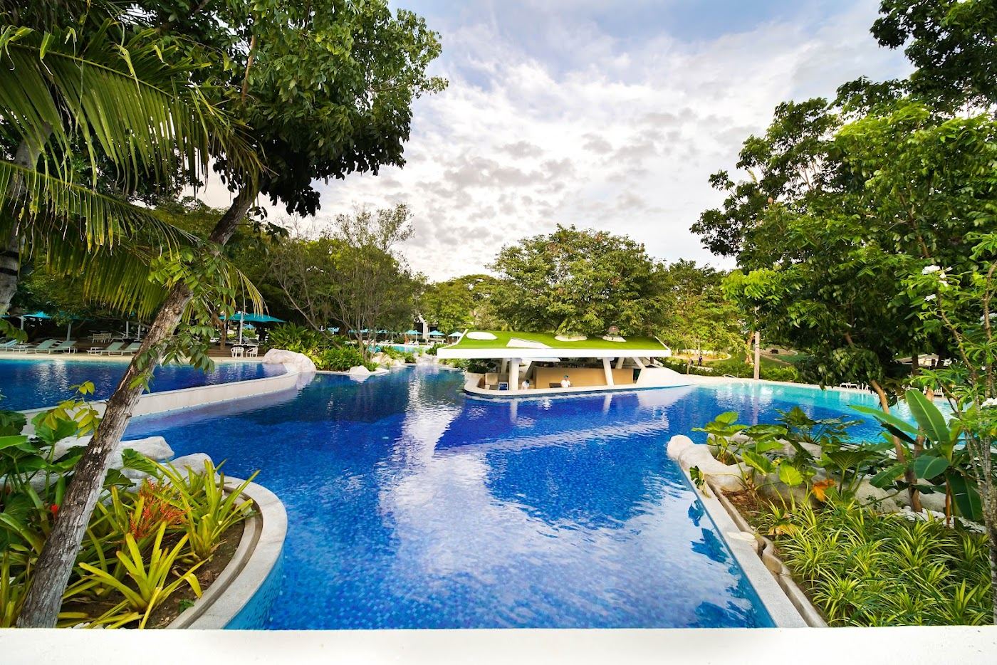 Calm shallow reef water and resort frontage at Tambuli on the east shore of Mactan Island in Cebu Philippines