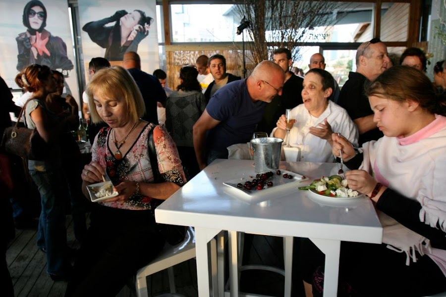 Seafront seafood tables at Manta Ray restaurant near Charles Clore beach in Tel Aviv