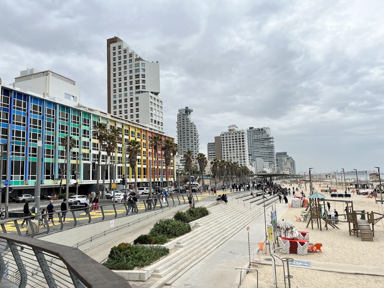 Golden evening light over the Mediterranean and the promenade on a Tel Aviv beach
