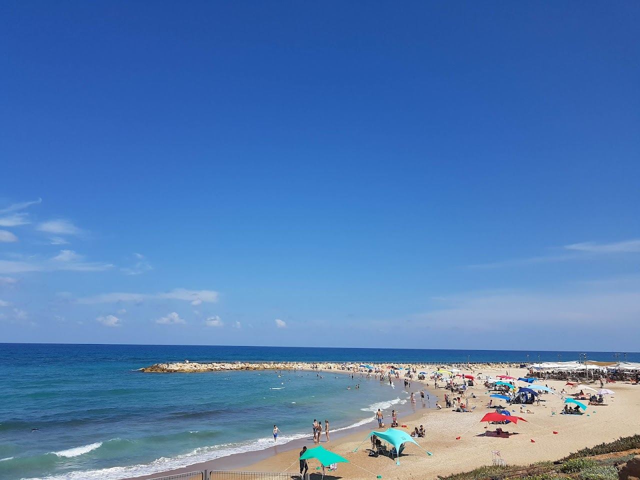 The calm sheltered bay and soft sand of Tel Baruch beach in north Tel Aviv