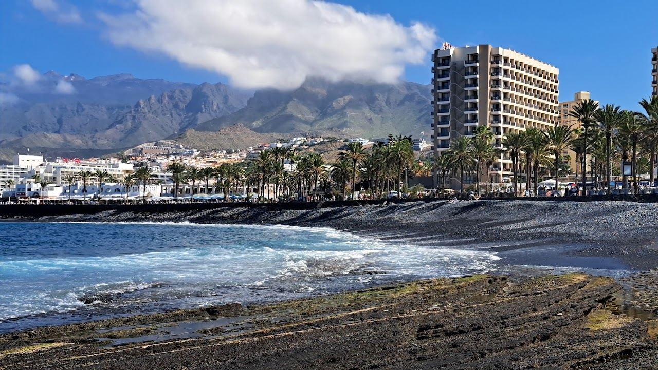 The resort beachfront and calm sheltered water of Playa de las Americas in Tenerife