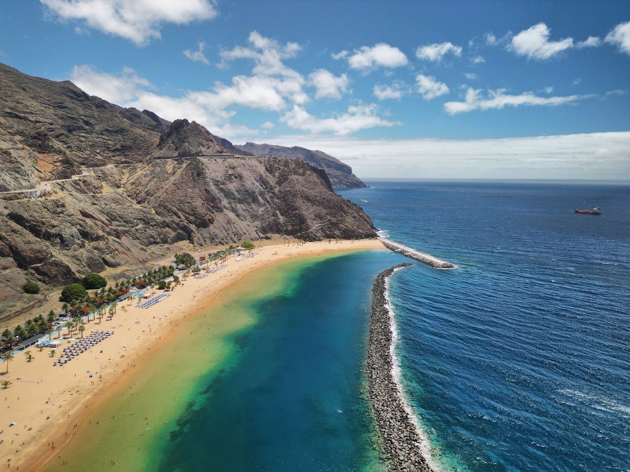 The golden sand and breakwater sheltered water of Playa de las Teresitas in Tenerife