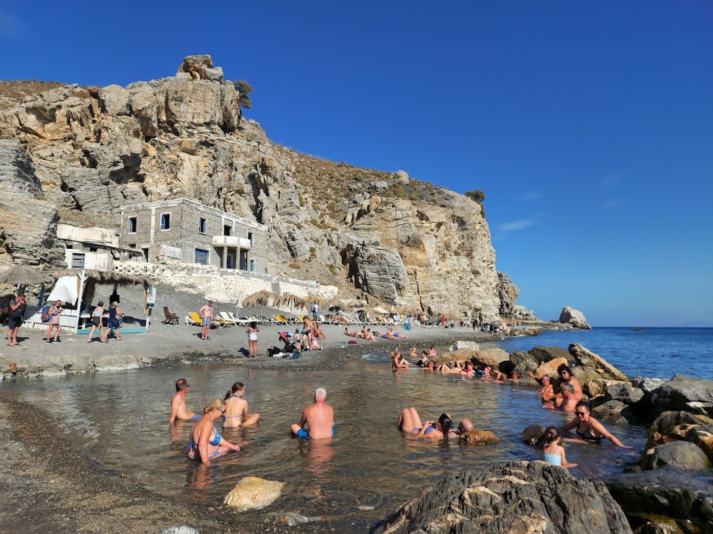 The natural thermal rock pool where the hot spring meets the sea at Therma Beach on Kos