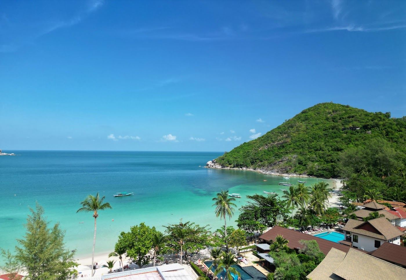 The clear water and resort fringed sand of the bay at Thong Nai Pan in Koh Phangan
