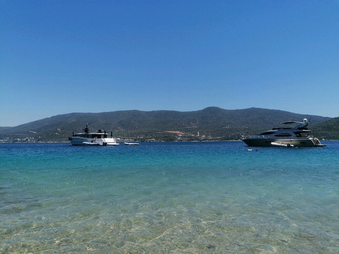 Torba sheltered northern bay with calm clear water and pine backed hills in Bodrum