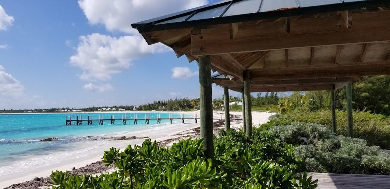 Powder white sand meeting clear shallow turquoise water at Treasure Cay Beach Abaco Bahamas