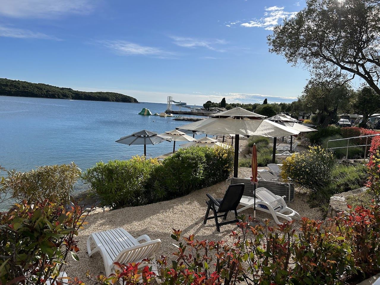 Long pebble shore and clear Adriatic water at the Valalta naturist resort north of Rovinj in Istria
