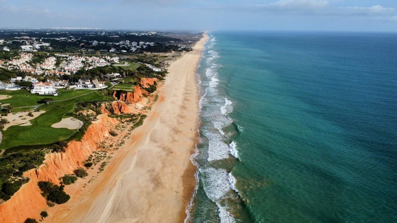 Praia do Vale do Lobo sand below ochre cliffs in the central Algarve
