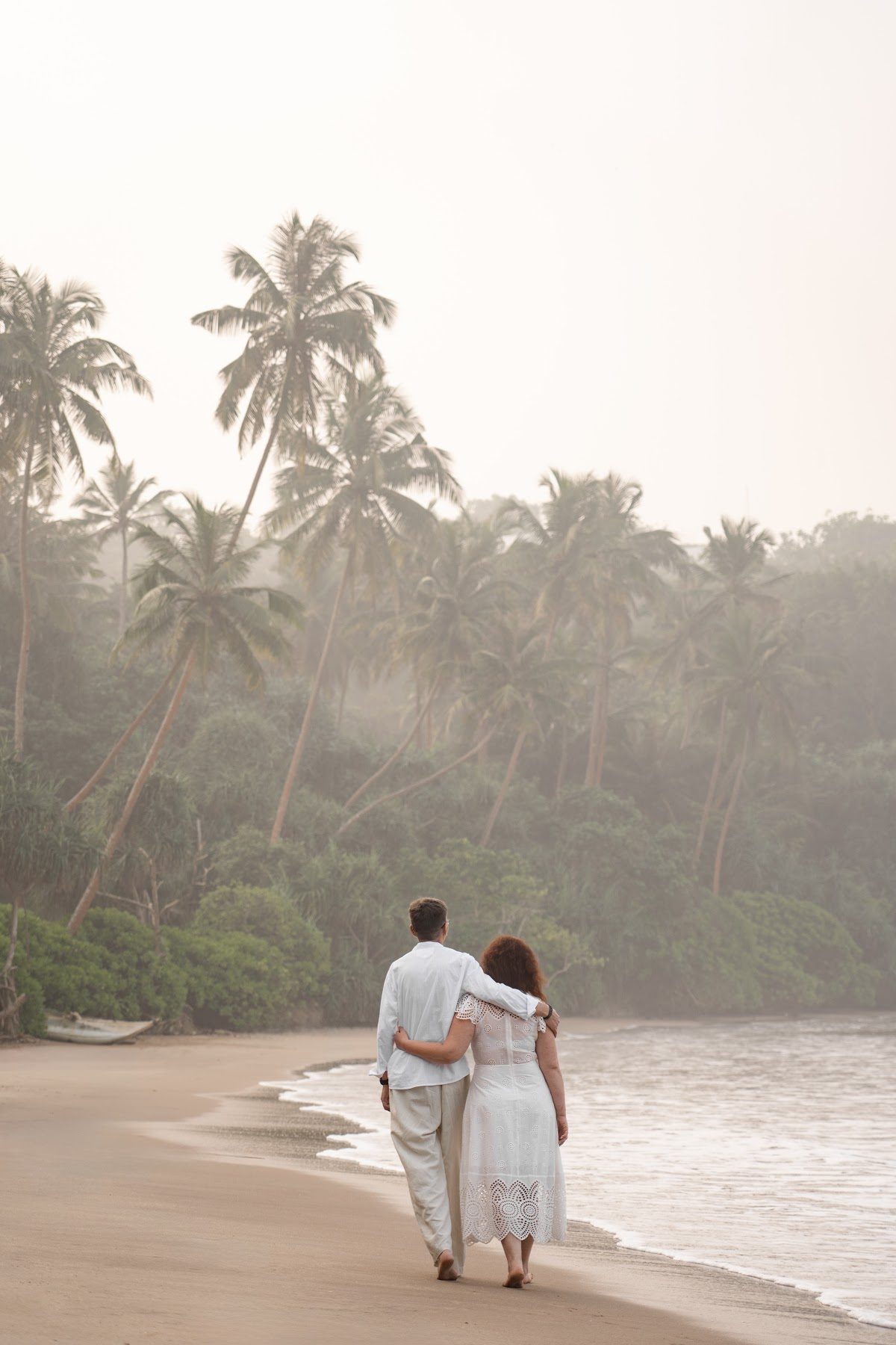 Palm topped headland above the sand at Mirissa in Sri Lanka