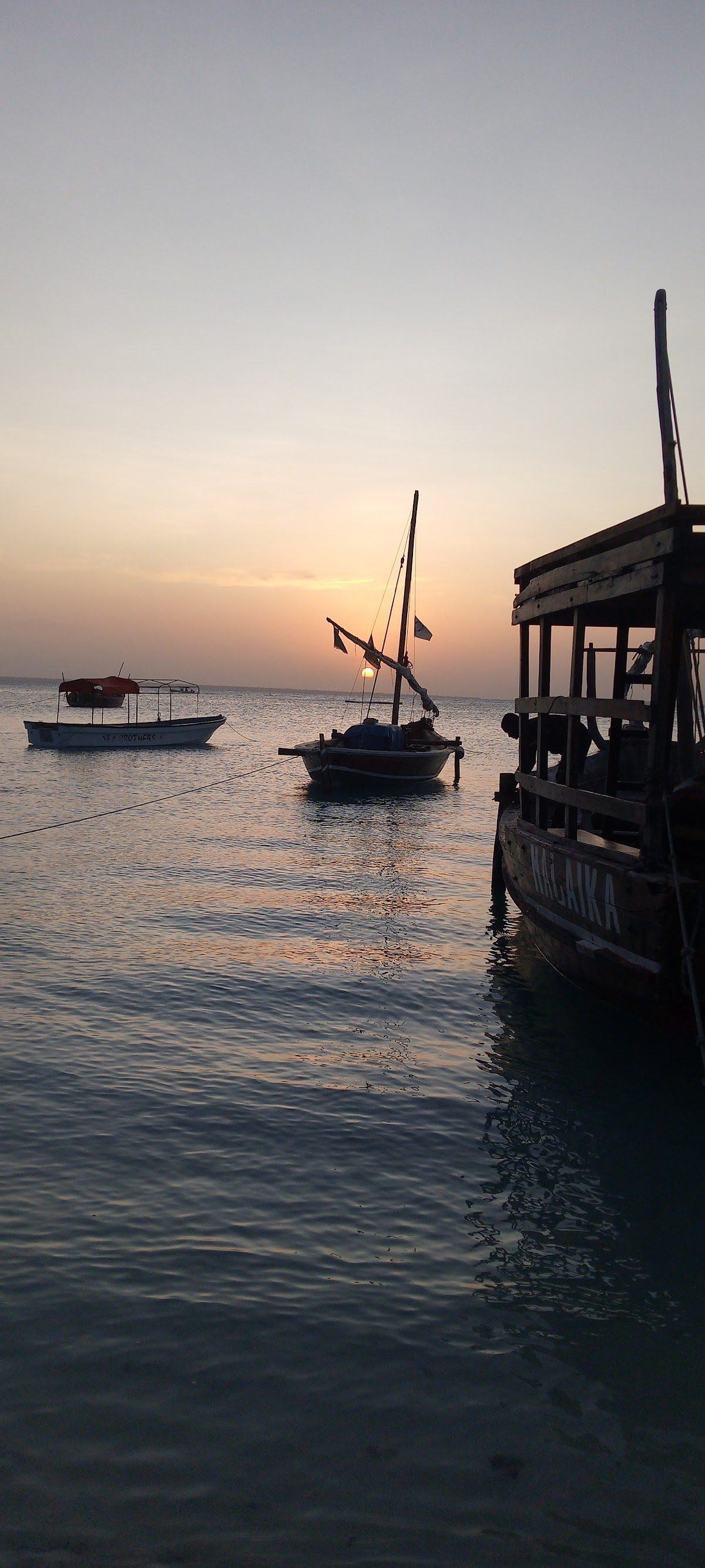 White sand and a wooden dhow on a Zanzibar beach