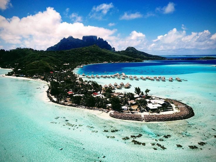 The shallow turquoise lagoon and palms of Matira Beach on Bora Bora