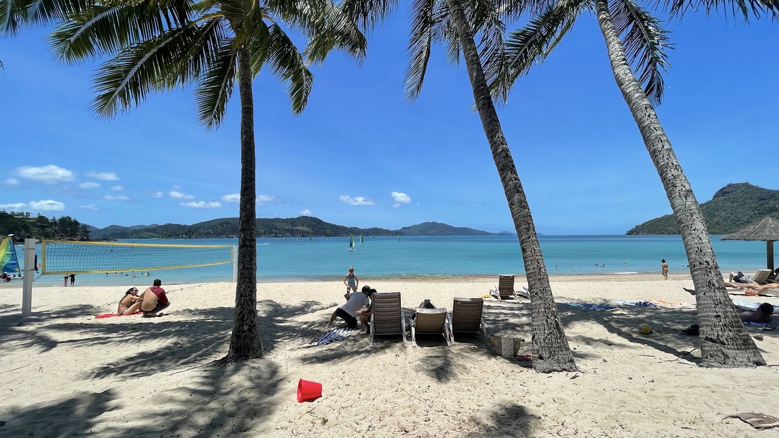 Palm fringed Catseye Beach and turquoise water on Hamilton Island in the Whitsundays