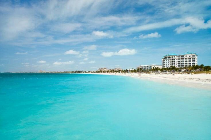 Calm clear turquoise water over pale sand at Grace Bay in Turks and Caicos