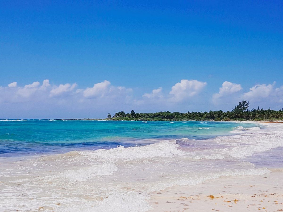 Long calm shallow turquoise bay and soft white sand at Xpu Ha in the Riviera Maya